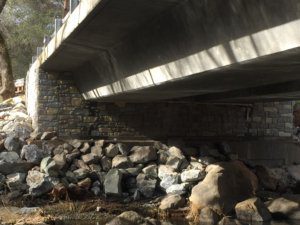A bridge with rocks under it and some water