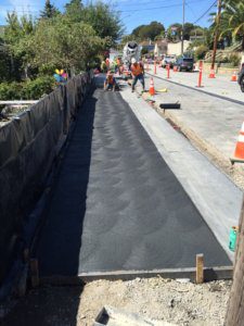 A road with asphalt being laid on it