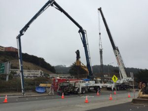 A crane lifting a truck.