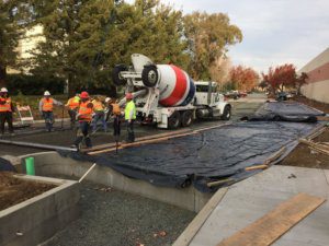 A concrete mixer is being used to pour concrete.