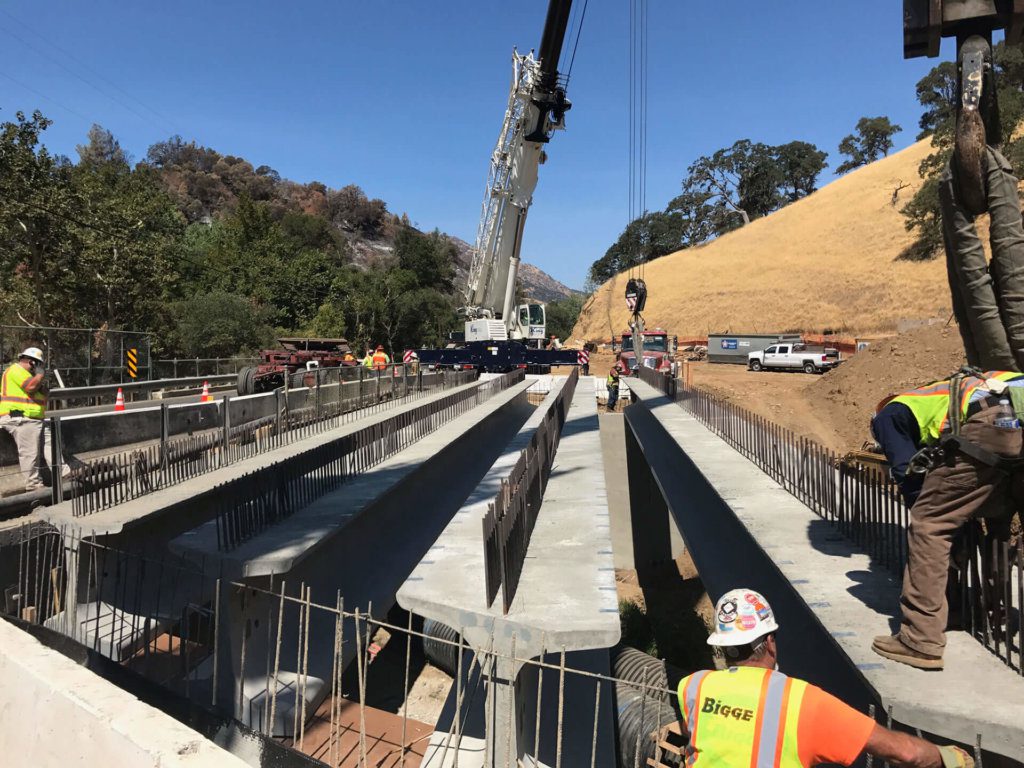 A group of construction workers are working on a bridge.