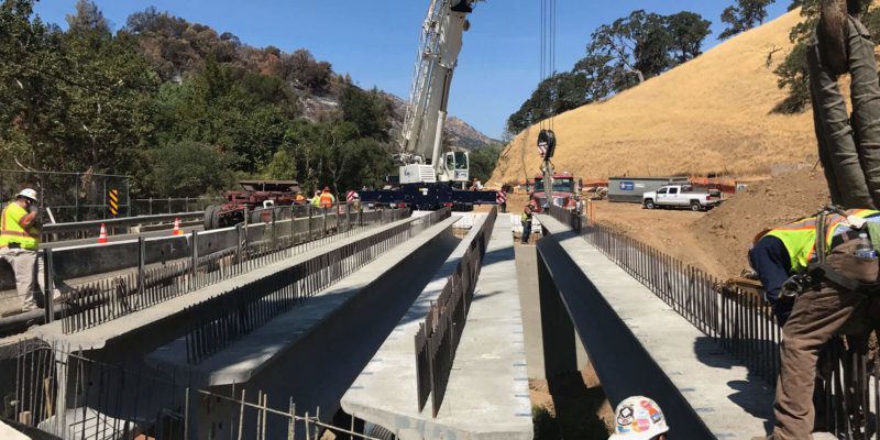 A group of construction workers are working on a bridge.