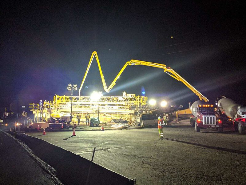 A construction site at night with a large crane.