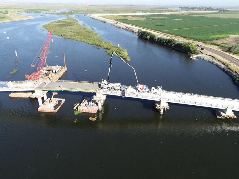 An aerial view of the construction of a bridge over a river.