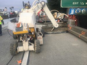A machine is working on the side of the road.
