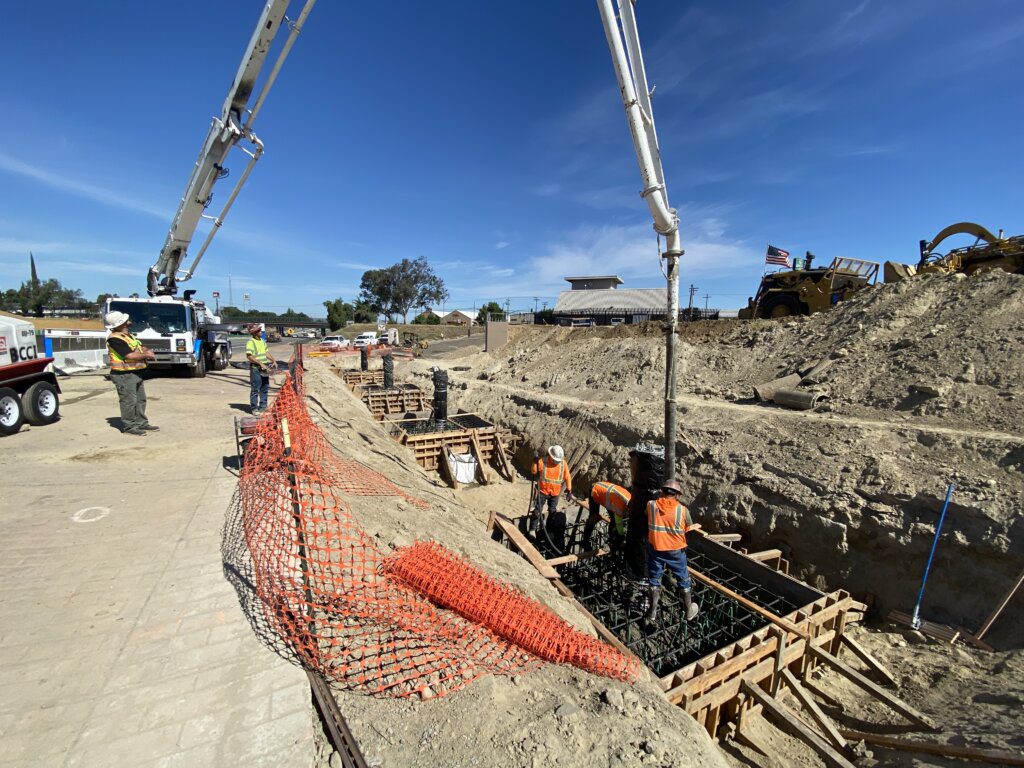 A construction site with workers working on the ground.