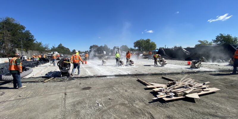 A group of people on motorcycles in the dirt.